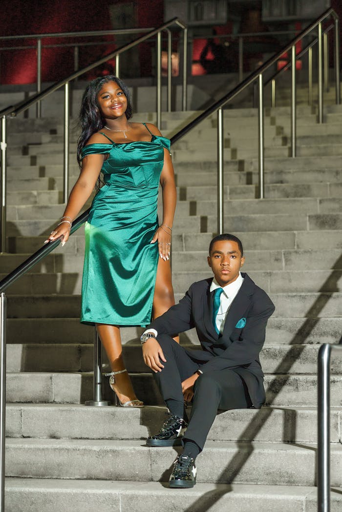 Crafting Captivating Headlines: Your awesome post title goes here Stylish teenagers posing on stadium steps in formal attire, celebrating a memorable homecoming night.